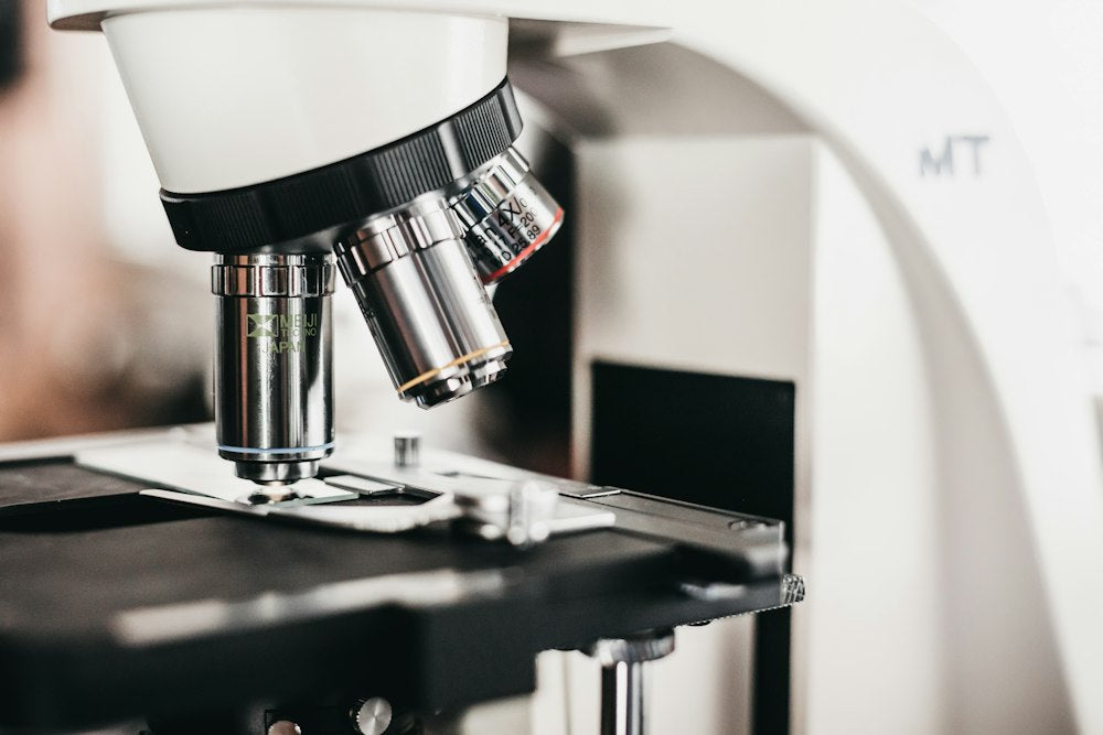 Close-up of microscope objective lenses above the stage